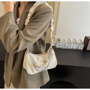 Detail of white satin hobo bag with pearl chain, silver metal strap and scrunchie handle
