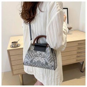 Detail of vintage jacquard bucket bag featuring wave patterns and wood handles