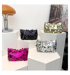 Detailed view of sparkly sequin handbags in various colors with metallic chain straps