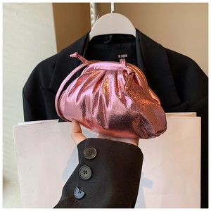 Detail of metallic pink pleated pouch bag with glossy finish and slim leather strap