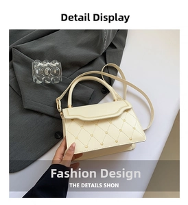 Detail showing cream quilted handbag with gold heart studs and chain edge trim