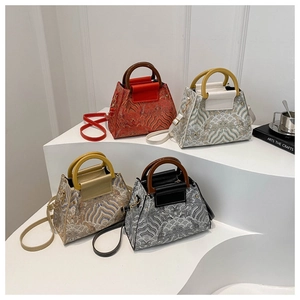 Detail of four embroidered bucket bags with wave patterns and detachable straps