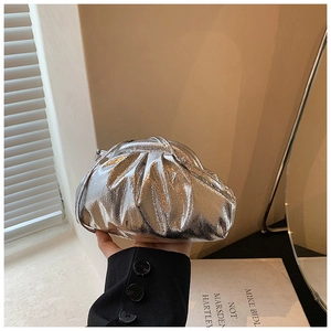 Detailed view of silver metallic pleated cloud bag with slim shoulder strap for women