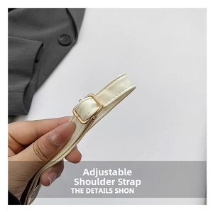Detail of adjustable cream white faux leather shoulder strap with gold metal buckle