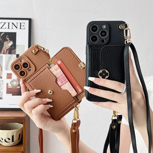 Detailed view of leather iPhone case with built-in card holder and clover metal logo