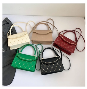 Detail of five multi-colored quilted crossbody bags with gold heart-shaped accents