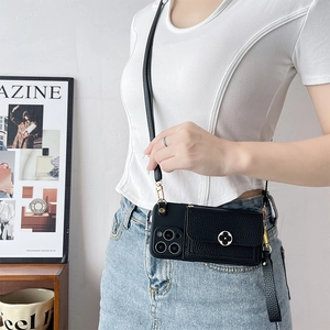 Detail view of black lychee grain leather crossbody phone case with flower metal clasp