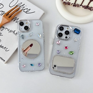 Glitter iPhone case with colorful gemstones and integrated rhinestone makeup mirror