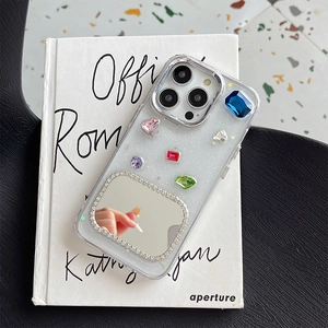 Detailed view of luxury iPhone case with colorful gemstones, glitter, and makeup mirror