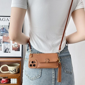 Brown litchi leather wallet phone case with crossbody strap and wristlet shown on a model