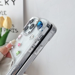 Macro shot of luxury iPhone case showing side buttons and elegant colorful rhinestones