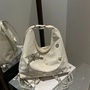 Chic off-white butterfly tote bag with pearl heart embellishments and silver chain straps