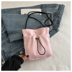 Detail of pink nylon phone bag with drawstring texture and silver magnetic snap button