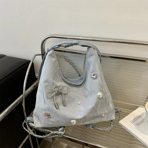 Light blue pleated tote bag with pearl butterfly charms and silver chain strap