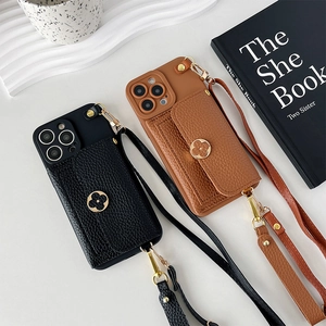 Detail of leather phone case featuring a floral clasp wallet and crossbody strap