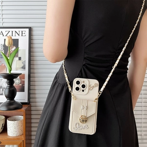 Crossbody iPhone case with bow, rhinestone accents, and leather-metal chain strap