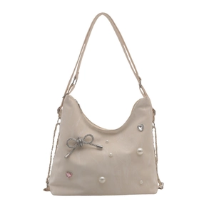 Chic beige shoulder bag with pearl accents, heart crystals, and diamond bow pendant