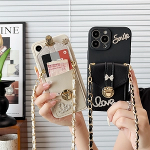 Detail of iPhone wallet case with crossbody chain and bowknot showing card storage