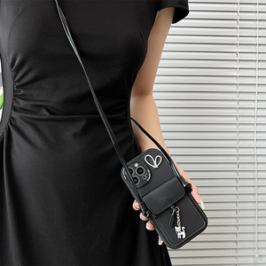Black leather iPhone case with vertical card wallet, cat pendant, and crossbody strap