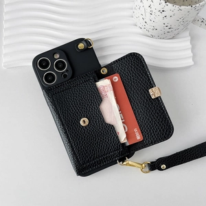 Detail of black lychee leather iPhone case with built-in wallet and gold metal clasp