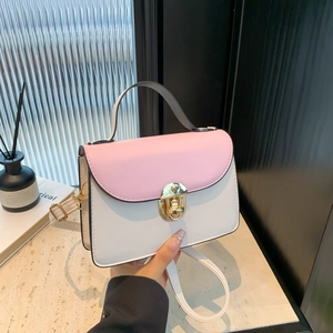 Pink and white contrast shoulder bag with golden round metal twist lock and top handle