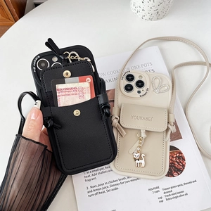 Close-up of iPhone wallet case with snap button card slot and luxury cat pendant