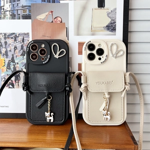 Detail of iPhone wallet cases with leather card slots, rhinestones, and cat pendants