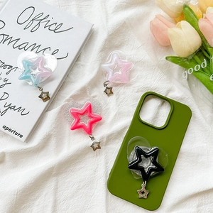 Sparkly heart phone grip with star charms in various colors on green case