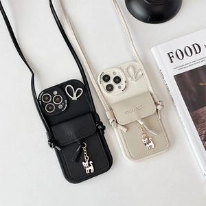 Detail view of crossbody iPhone wallet case with card holder and cat charm
