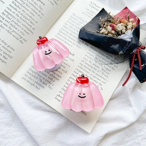Detailed view of pink translucent jelly phone grips with cherry decor and smiley face