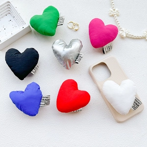 Colorful plush heart-shaped collapsible phone grip stand set in seven vibrant colors