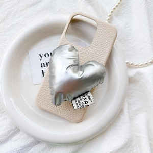 Cream leather phone case with large 3D silver heart pop socket on ceramic plate