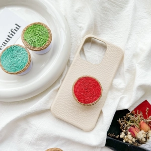 Ins style woven color-block phone socket on cream leather case with minimalist aesthetic