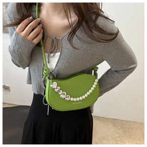 Green half-moon saddle bag with pearl heart chain and Fashion & Bags text print