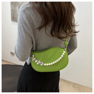 Detail of lime green crescent shoulder bag with heart pearl chain and fashion text