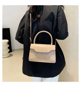 Detail of apricot crossbody bag with scalloped flap and heart-shaped quilted texture