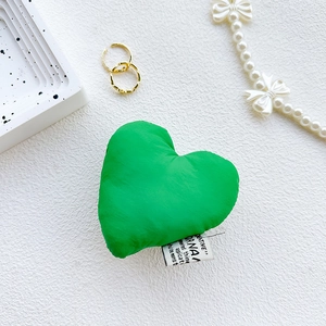 Detail of creative green heart fabric phone grip with woven label and plush texture