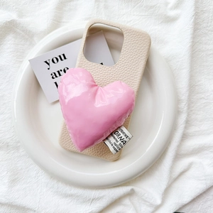 3D pink puffy heart phone case with cream lychee leather texture and fabric label