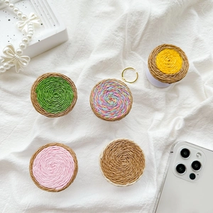 Detail view of woven pop-style phone sockets in vibrant assorted colors on fabric