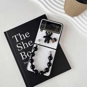 Detail of Galaxy Z Flip case with black bead chain, 3D bear charm and coffee cup motif