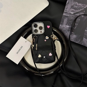 Detail of black iPhone case with quilted mini crossbody bag and glitter heart rhinestones