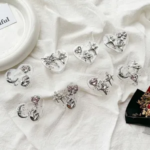 Eight heart-shaped resin phone grips featuring silver bows and celestial motifs, styles 1-8
