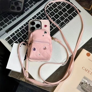 Pink iPhone crossbody wallet case with mini backpack design and heart rhinestones detail