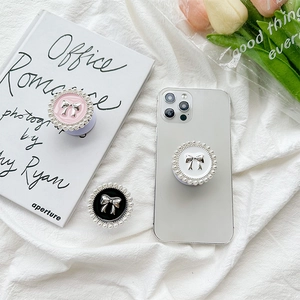 Pink white and black phone grip set with pearl edges and silver bow decoration