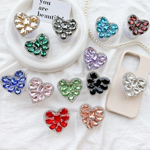 Luxe heart-shaped rhinestone phone socket grips in multiple vibrant gemstone colors