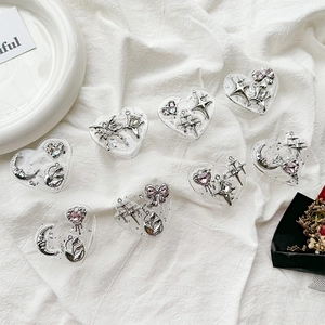 Detailed view of heart-shaped resin phone grips with silver stars and moon charms