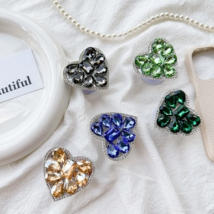Luxurious heart-shaped rhinestone phone sockets in various colors on white fabric