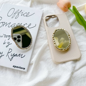 Irregular mirror phone grip stand with metallic frame on beige leather case