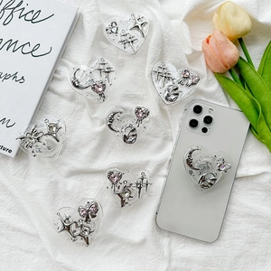 Macro shot of heart-shaped phone grips with silver resin moon and star charms
