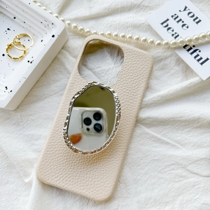 Elegant cream leather iPhone case with silver wavy irregular vanity mirror on back